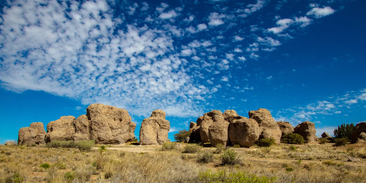 Enormous volcanic boulders beneath a blue sky at City of Rocks State Park